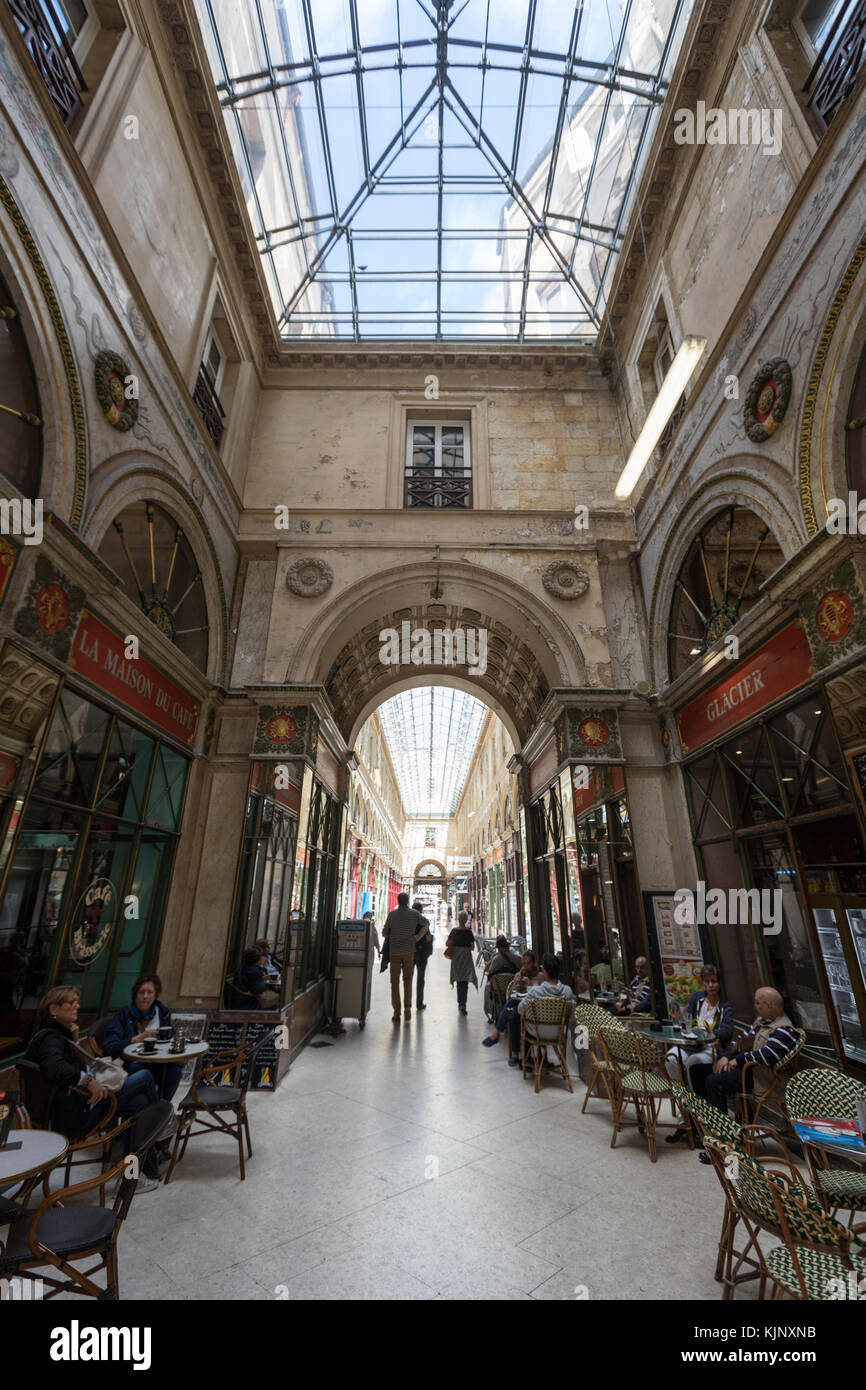 People seated having coffee  outside a bar in Galerie bordelaise Arcade  in Bordeaux, France Stock Photo