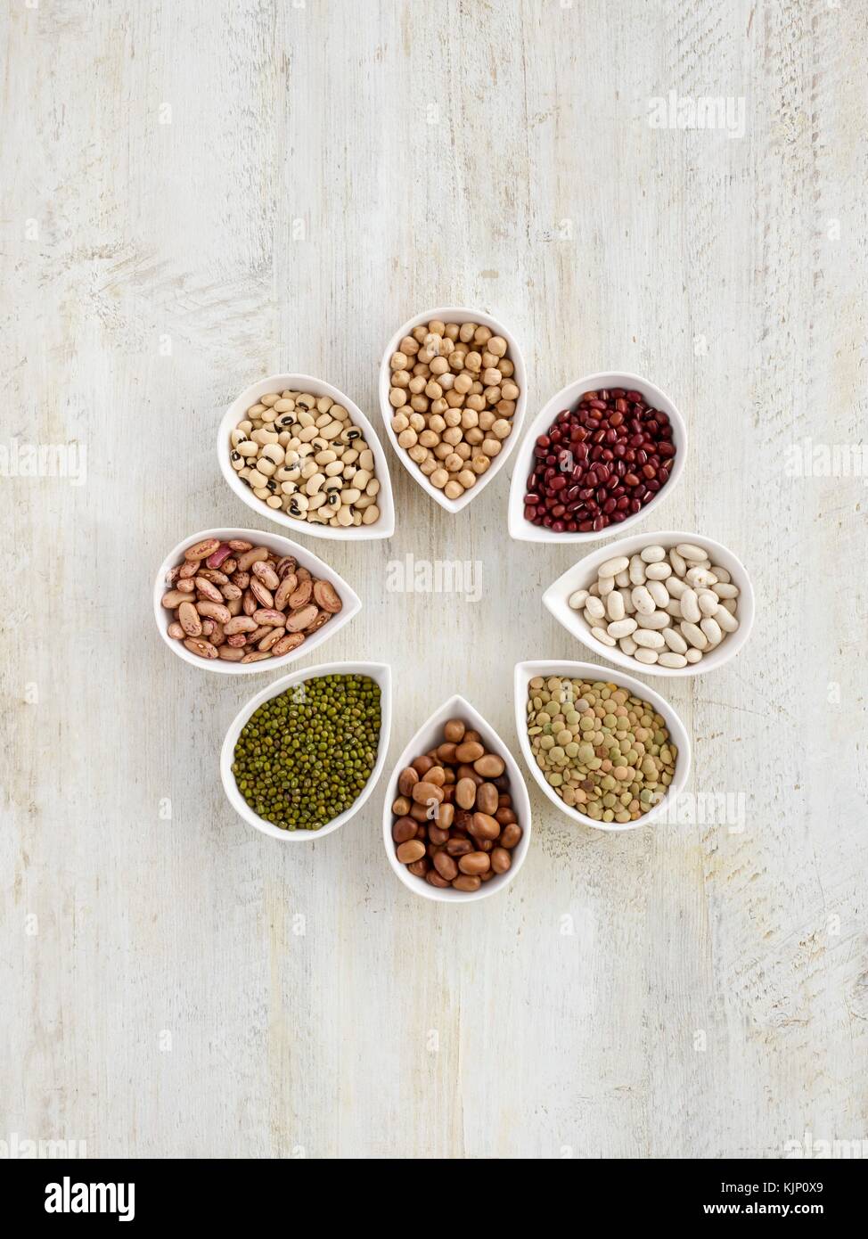 Pulses in tear shaped mini bowls, overhead view. Stock Photo