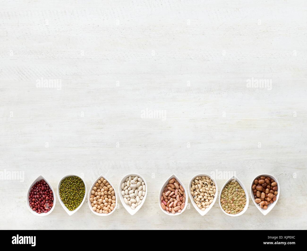 Pulses in tear shaped mini bowls, overhead view. Stock Photo