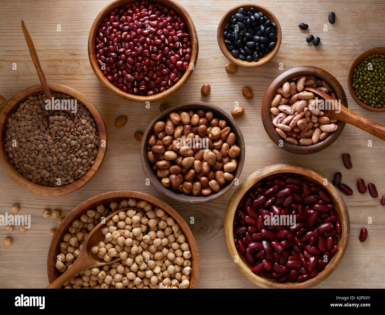 Pulses in wooden bowls, overhead view. Stock Photo