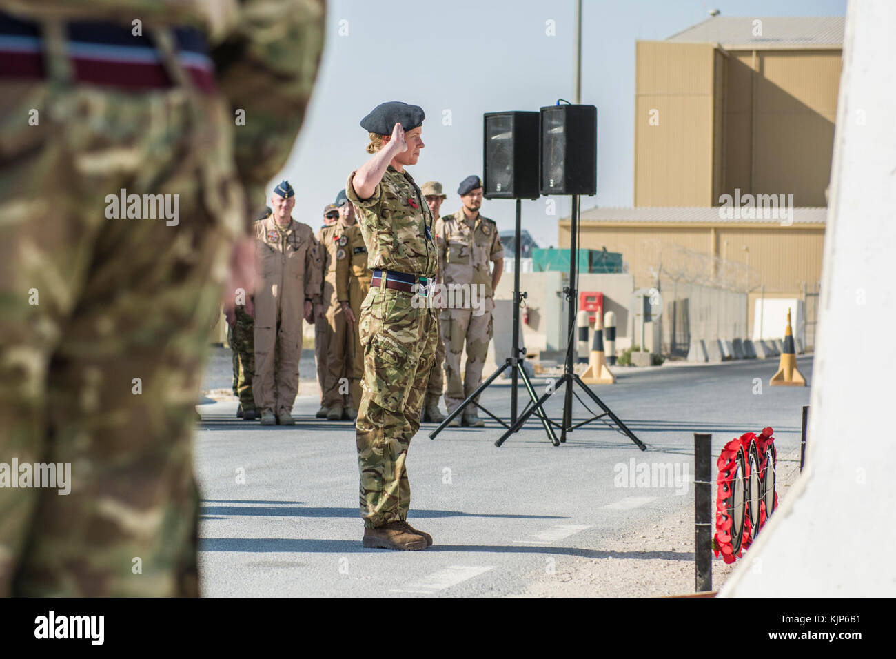 A member of the Royal British Air Force, lays a wreath and salutes