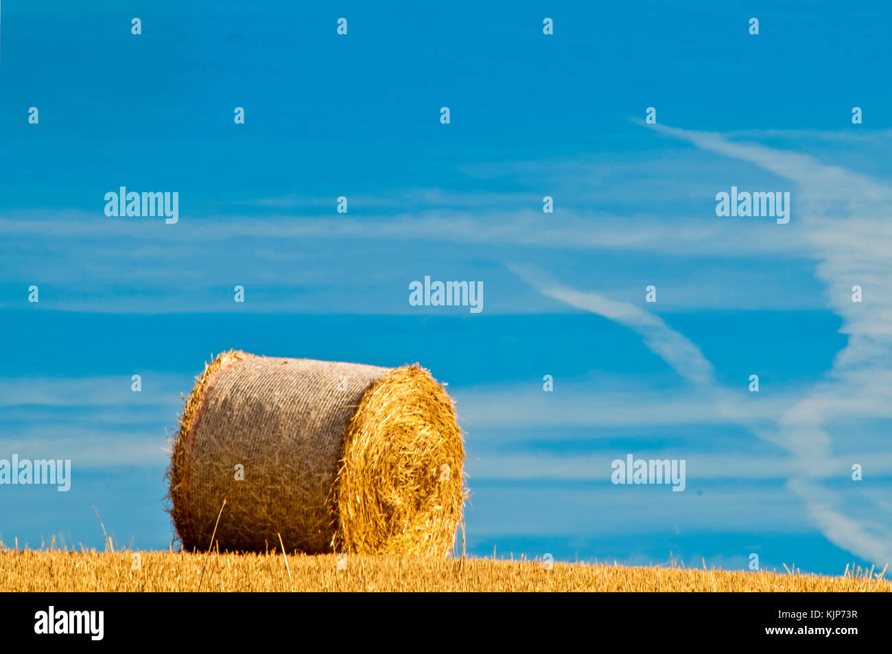 bale of straw with a blue sky Stock Photo - Alamy