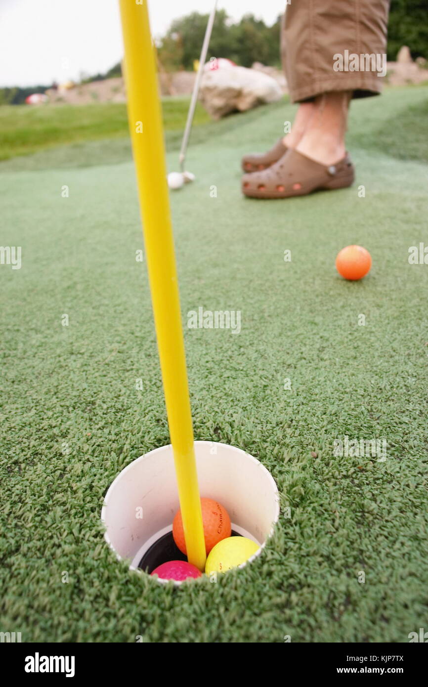 Close up of a pin and cup on a golf hole Stock Photo Alamy