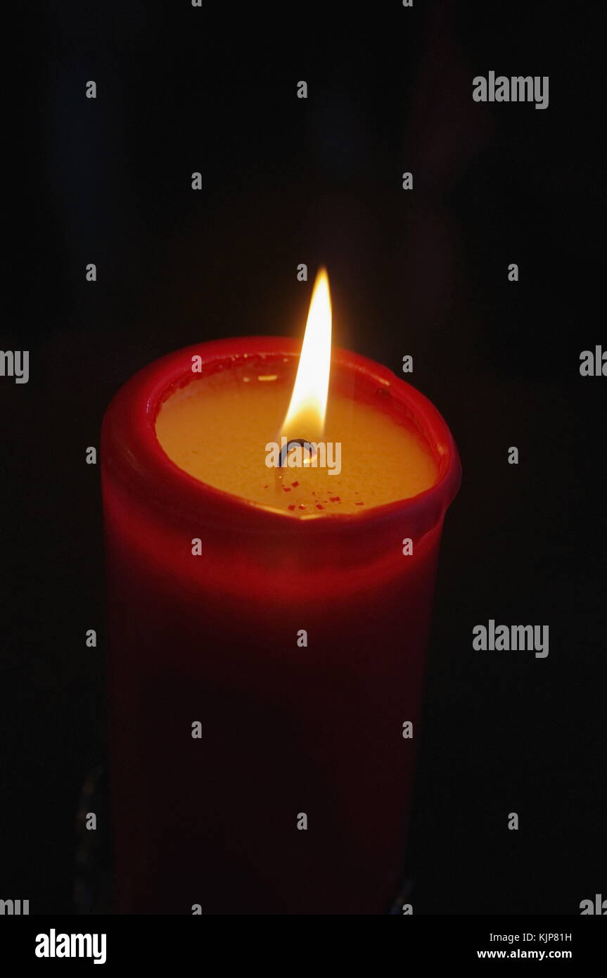 Closeup of burning candle isolated on black background Stock Photo - Alamy