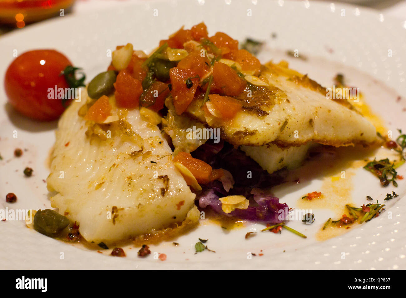 Fillet of a sole fish with fresh vegetables, with cherry tomatoes and