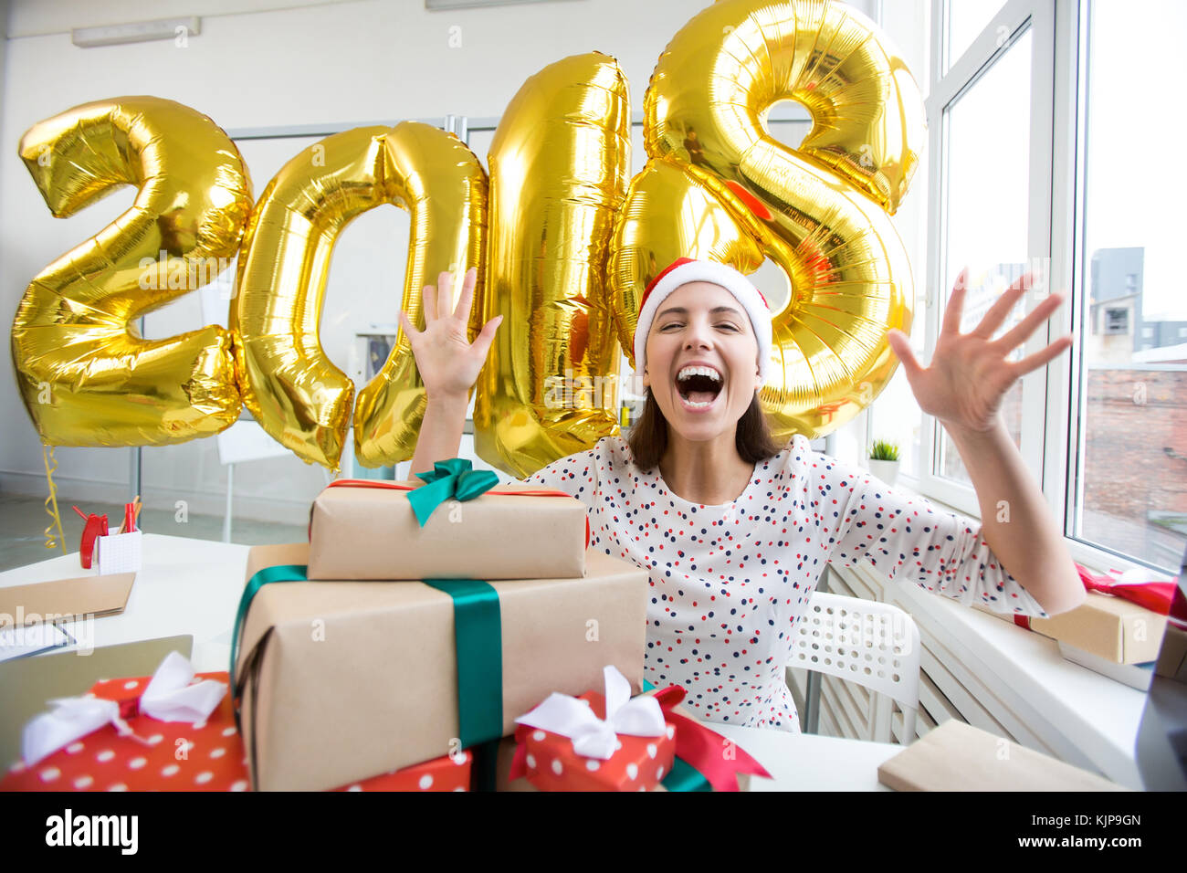 Ecstatic woman in Santa cap expressing her gladness of new 2018 year coming Stock Photo