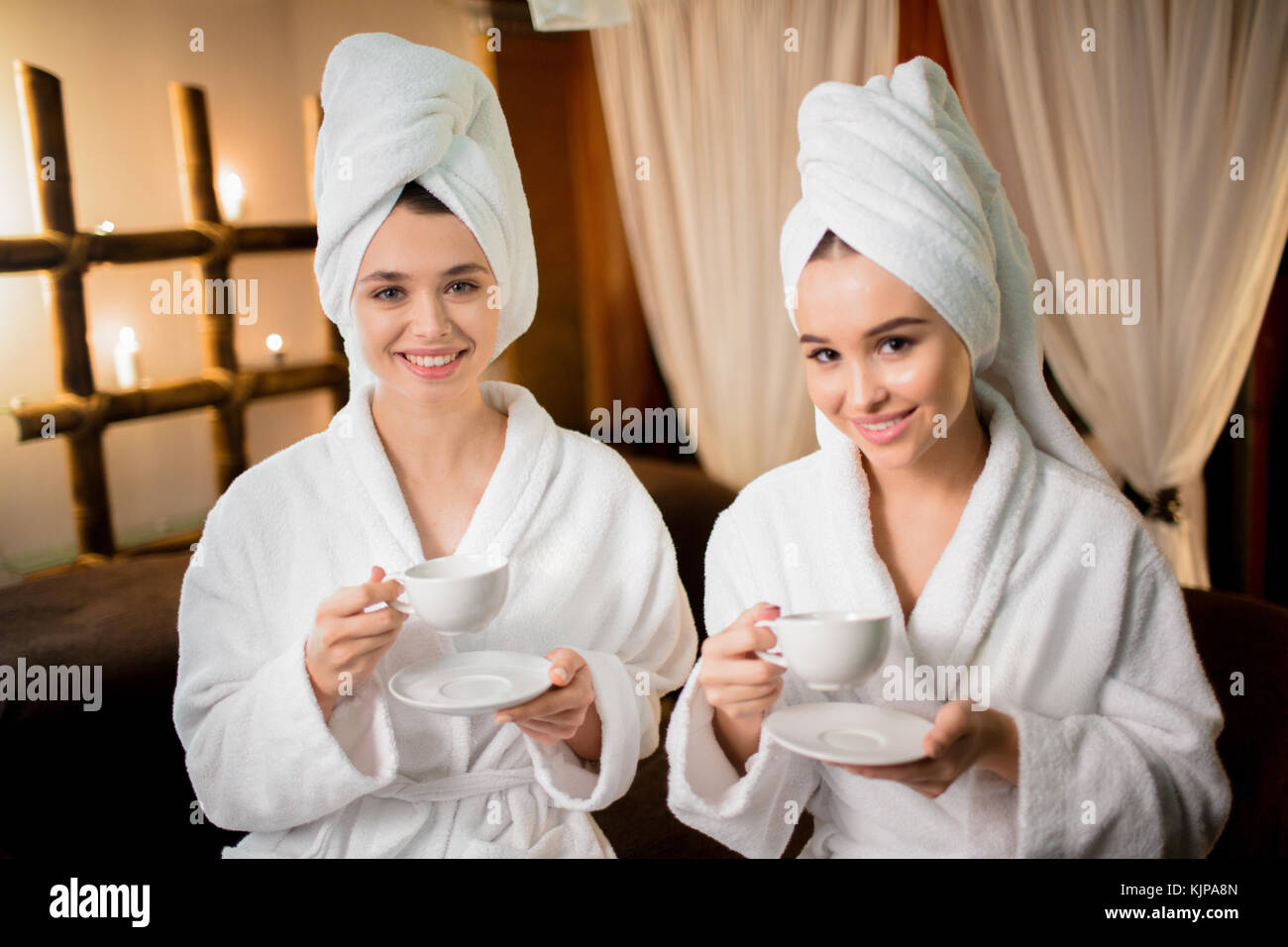 Restful females in bathrobes having herbal tea after hammam in spa salon  Stock Photo - Alamy