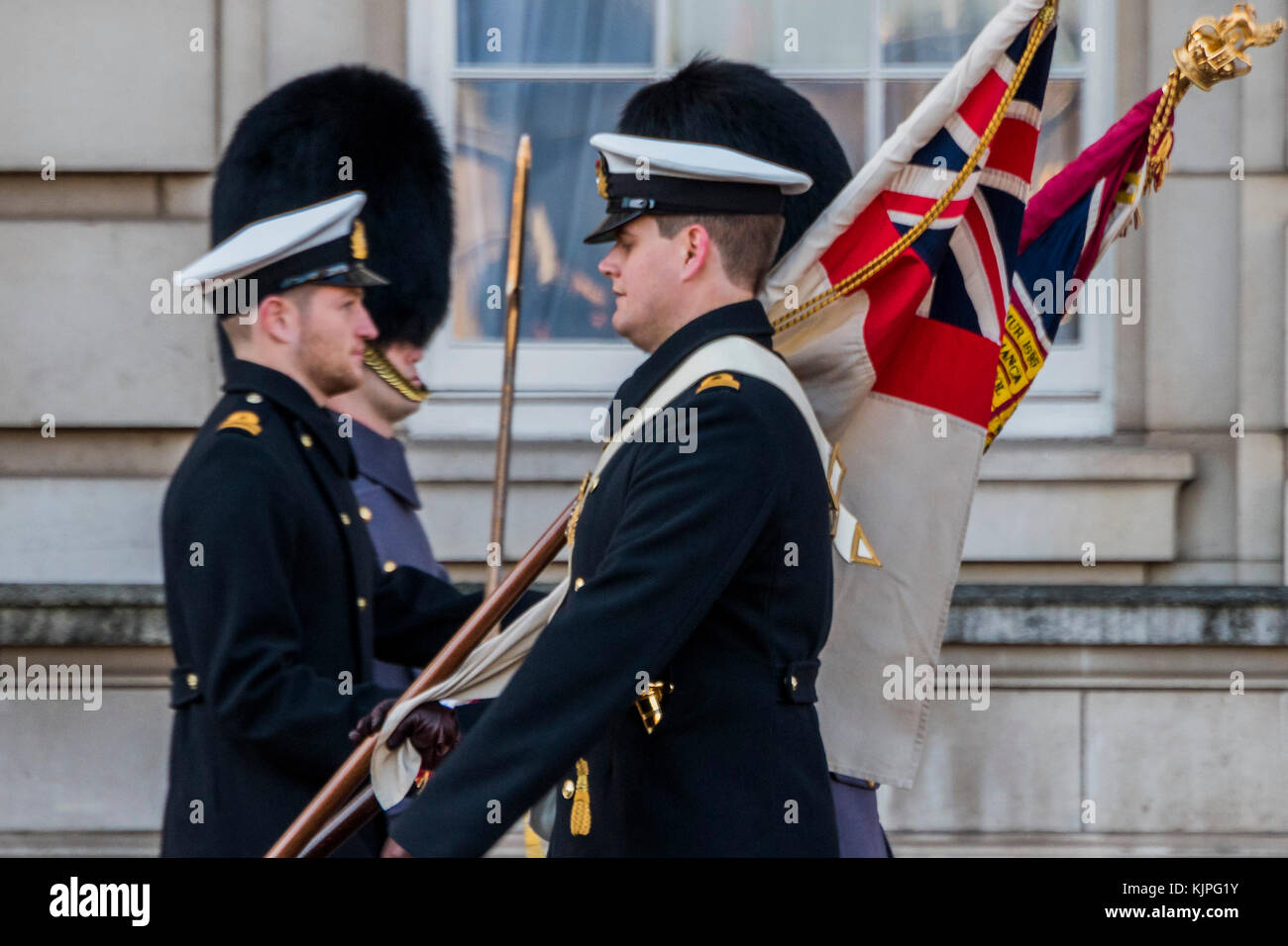 London, UK. 26th Nov, 2017. The White ensign and Regimental colours are paraded together - The Royal Navy take over the guard duty at Buckingham Palace for the first time. They take part in the traditional 'Changing the Guard' ceremony, taking over from one of the Regiments of Foot Guards. Credit: Guy Bell/Alamy Live News Stock Photo