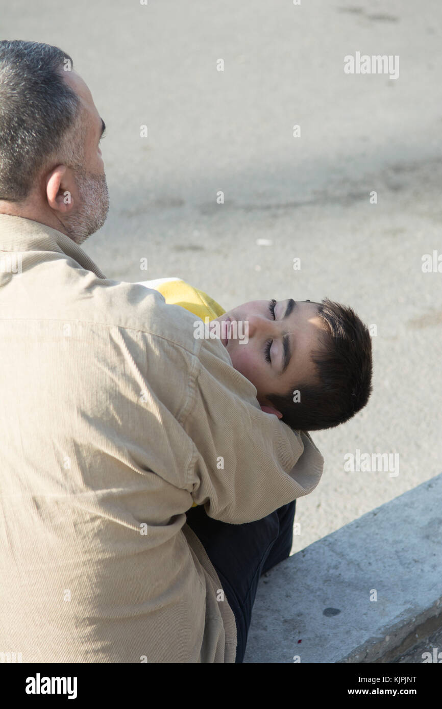 Marytrs' Square, Beirut , Lebanon, 26th Nov 2017,   Syrian refugee father and child sat on the street waiting for donation  Beirut , Lebanon, Credit: Mohamad Itani / Alamy Live News Stock Photo