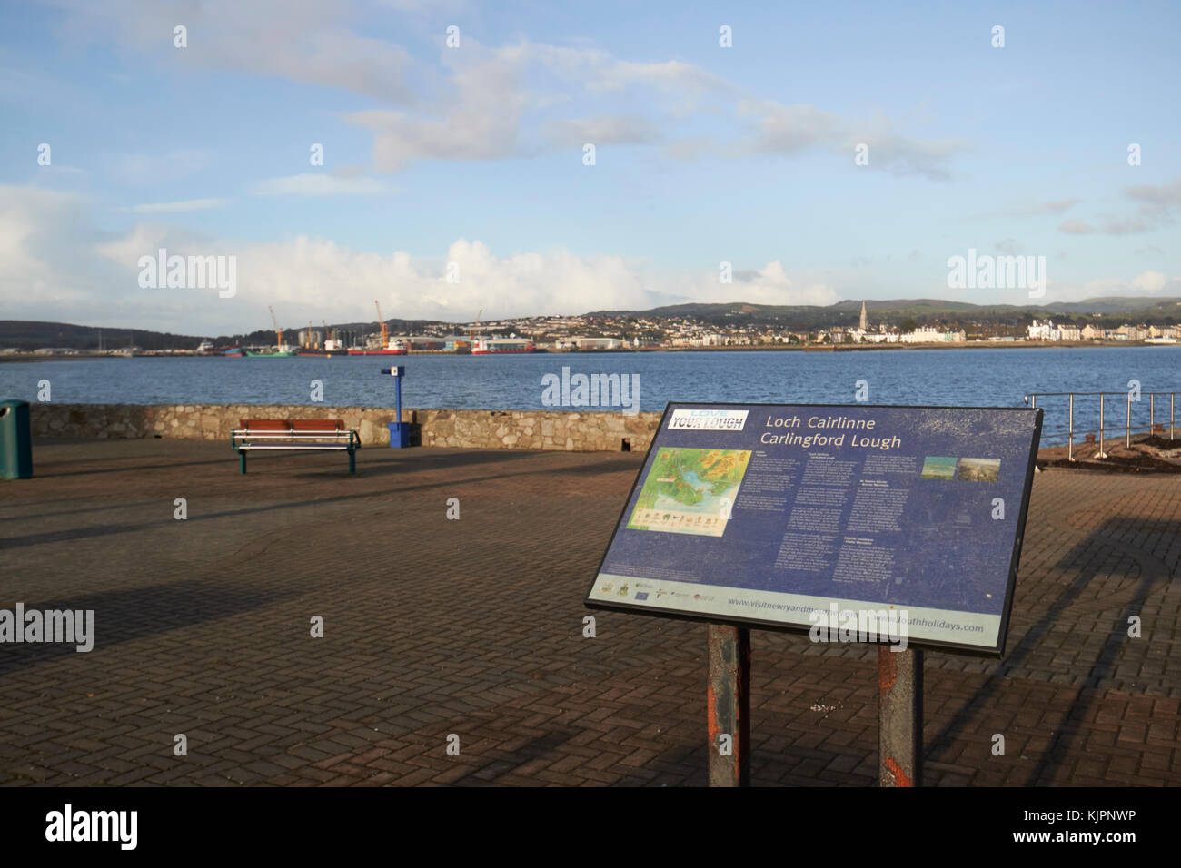 carlingford lough marking the irish border between Northern Ireland and Republic of Ireland soon to be the UK EU land border post Brexit. Sign in the foreground is in Omeath in the Republic of Ireland and the port of Warrenpoint in Northern Ireland is in the background Credit: Radharc Images/Alamy Live News Stock Photo