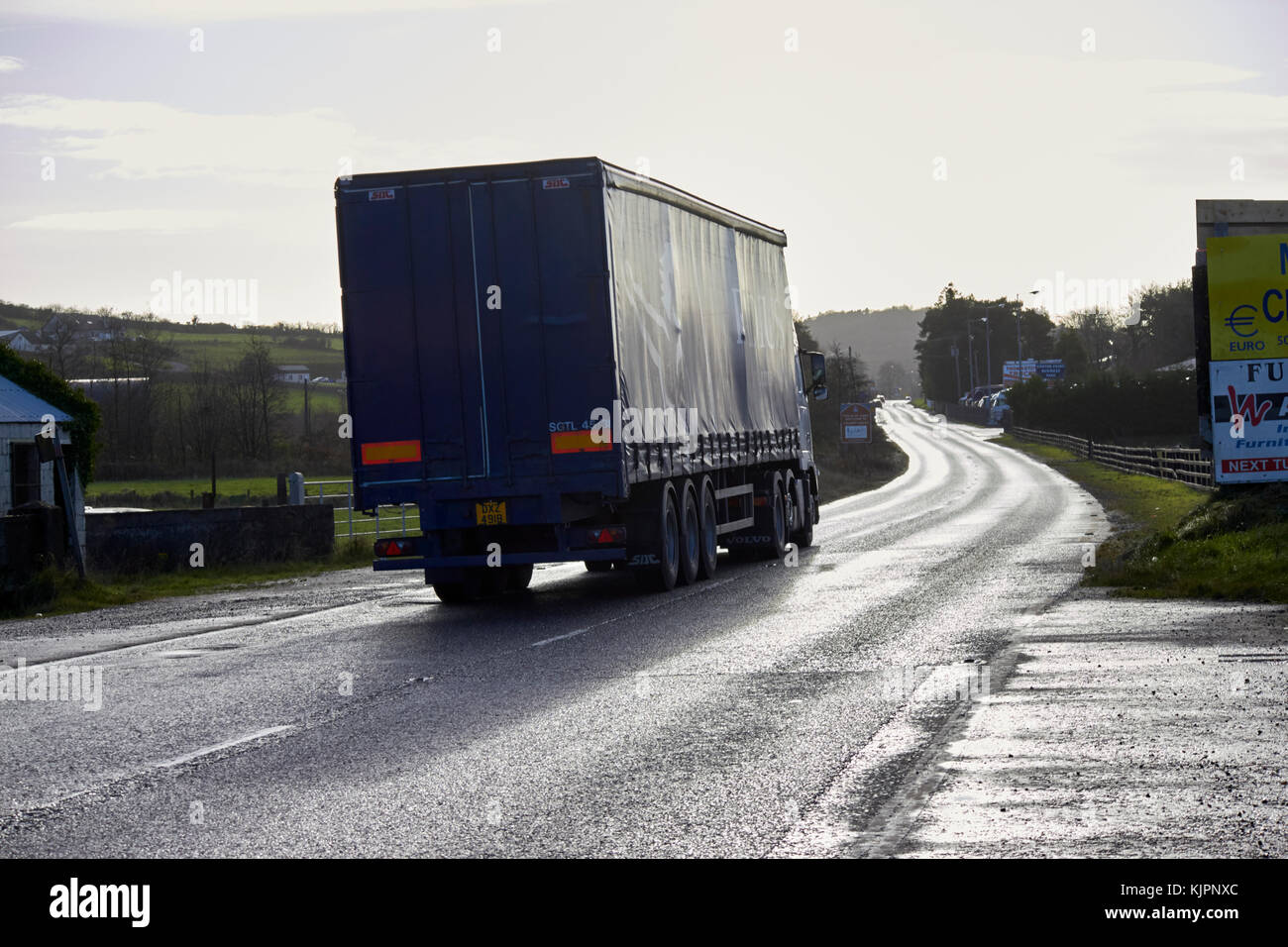 northern ireland freight traffic crossing the irish border between Northern Ireland and Republic of Ireland soon to be the UK EU land border post Brexit. The divided tarmac in the road marking the border on the A1 road the former main route between Belfast and Dublin. Credit: Radharc Images/Alamy Live News Stock Photo
