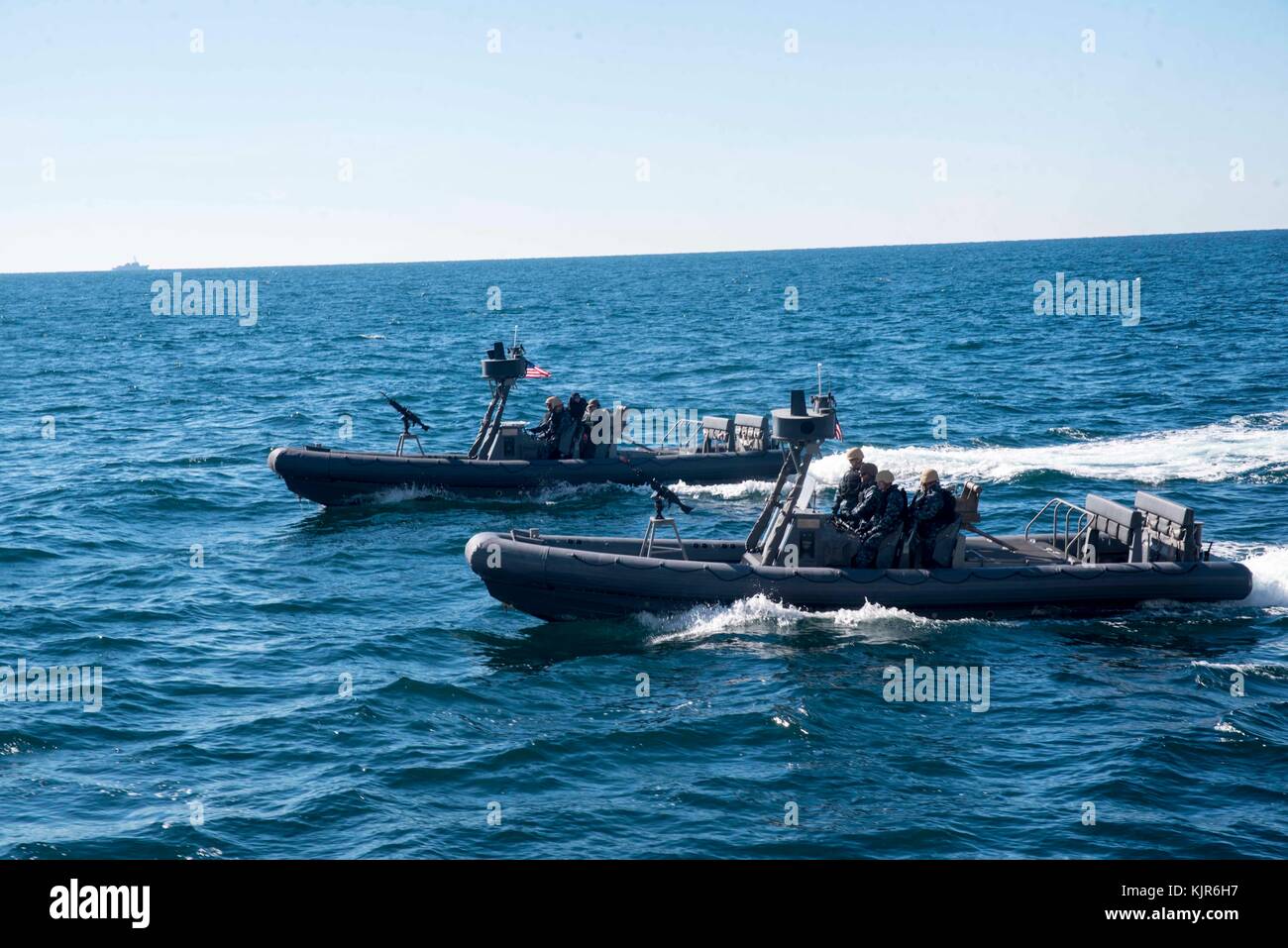 Two 11-meter Navy Special Warfare Rigid Inflatable Boats prepare to pick up Marines from the amphibious transport dock Stock Photo