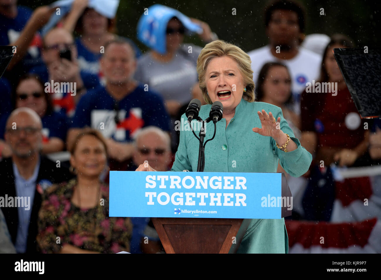 PEMBROKE PINES, FL - NOVEMBER 05: Supporters look in the pouring rain on as Democratic presidential nominee and former Secretary of State Hillary Clinton speaks during a campaign rally at C.B. Smith Park on November 5, 2016 in Pembroke Pines, Florida. With three days to go until election day, Hillary Clinton is campaigning in Florida and Pennsylvania  People:  Hillary Clinton Stock Photo