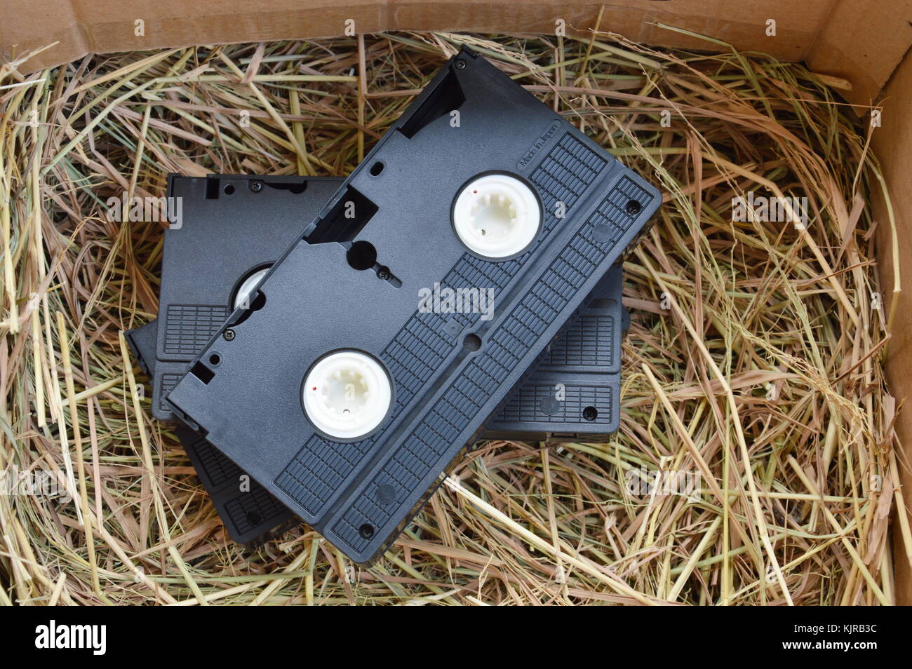 video tape recorder on dry straw in brown paper box Stock Photo Alamy