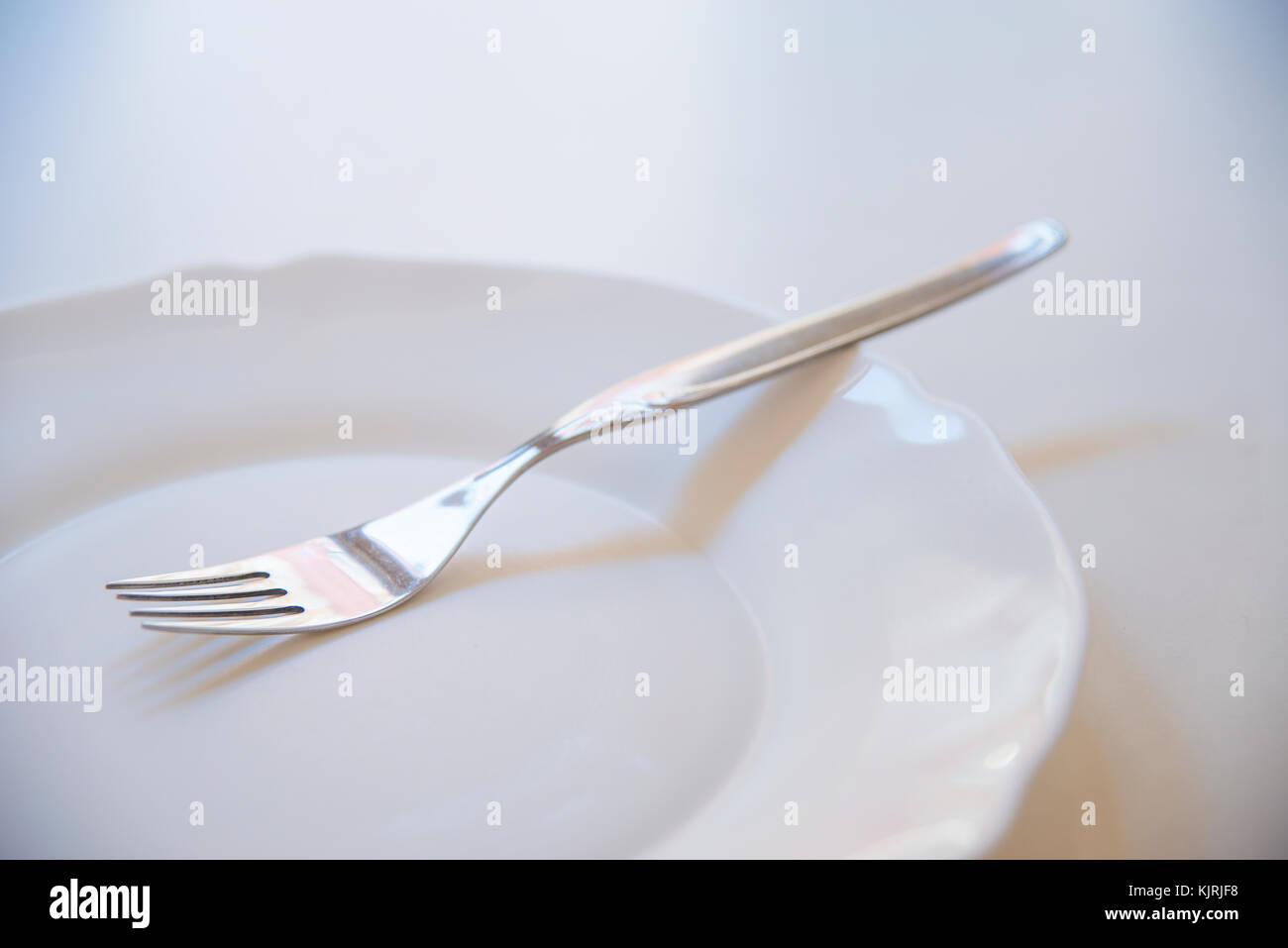 Fork on empty dish. Stock Photo