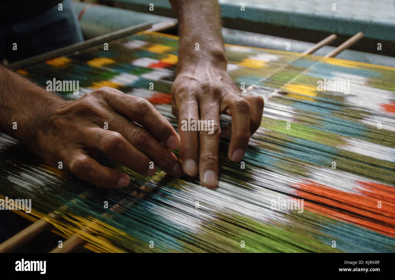 weaving and manufacturing of handmade carpets closeup. man's hands behind a loom Stock Photo Alamy