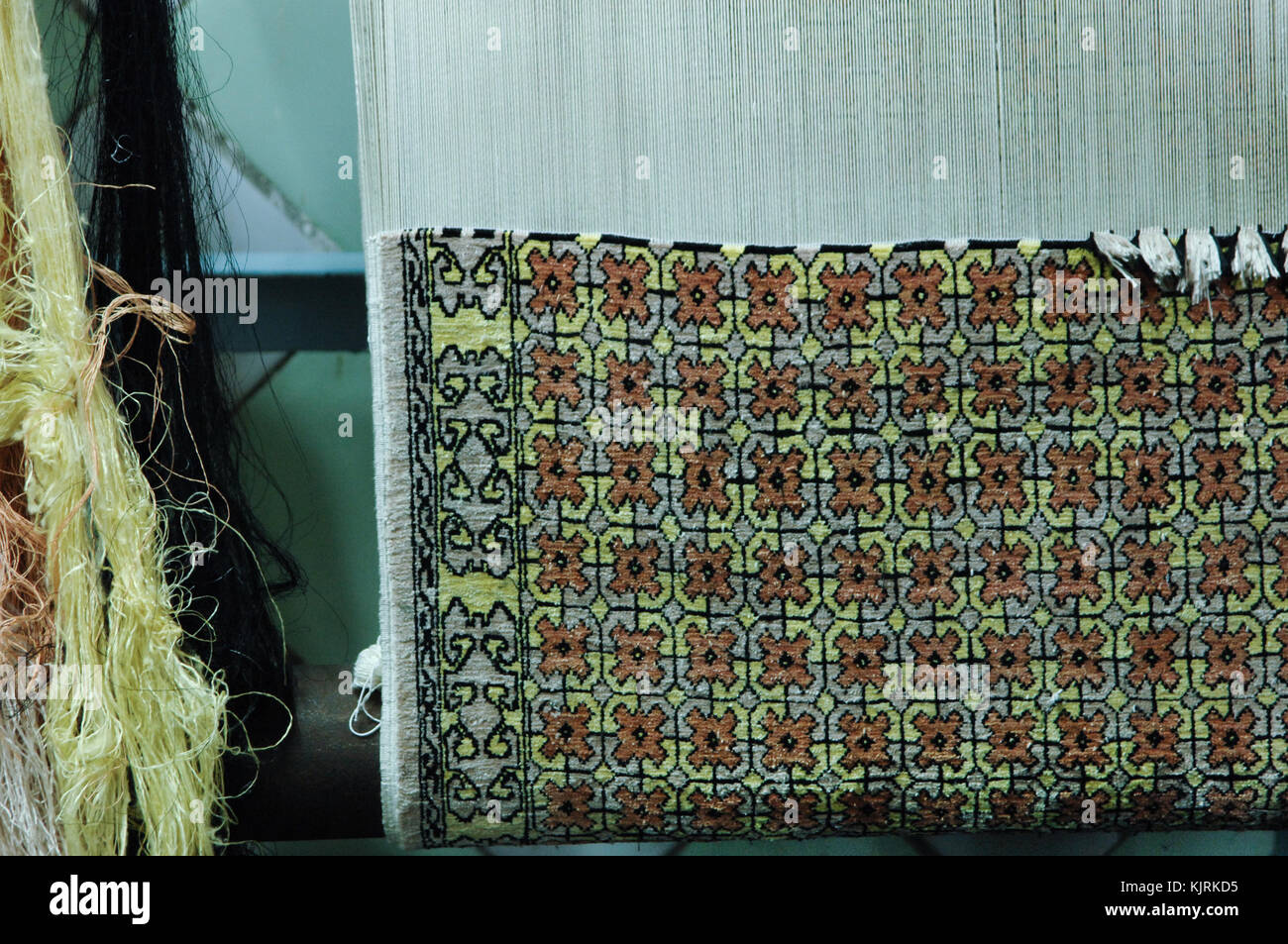 weaving and manufacturing of handmade carpets closeup. carpet in the making process Stock Photo