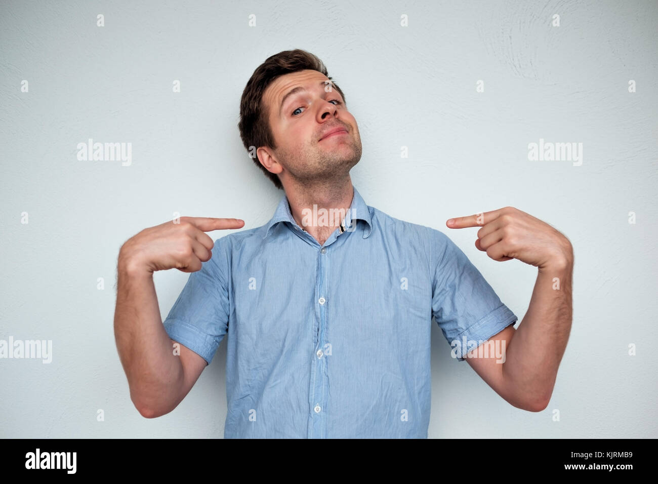 Self-satisfied and proud caucasian young man looks forward Stock Photo