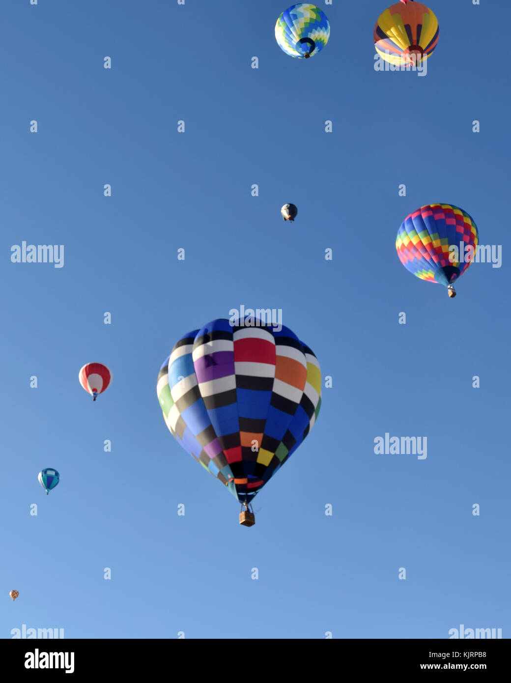 Colorful hot air balloons against blue sky Stock Photo - Alamy