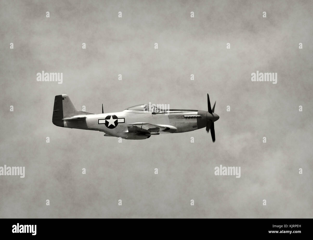 World War II era fighter plane in flight side view Stock Photo