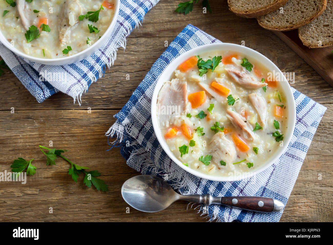 Split pea soup with smoked ham and croutons on grey background. Healthy