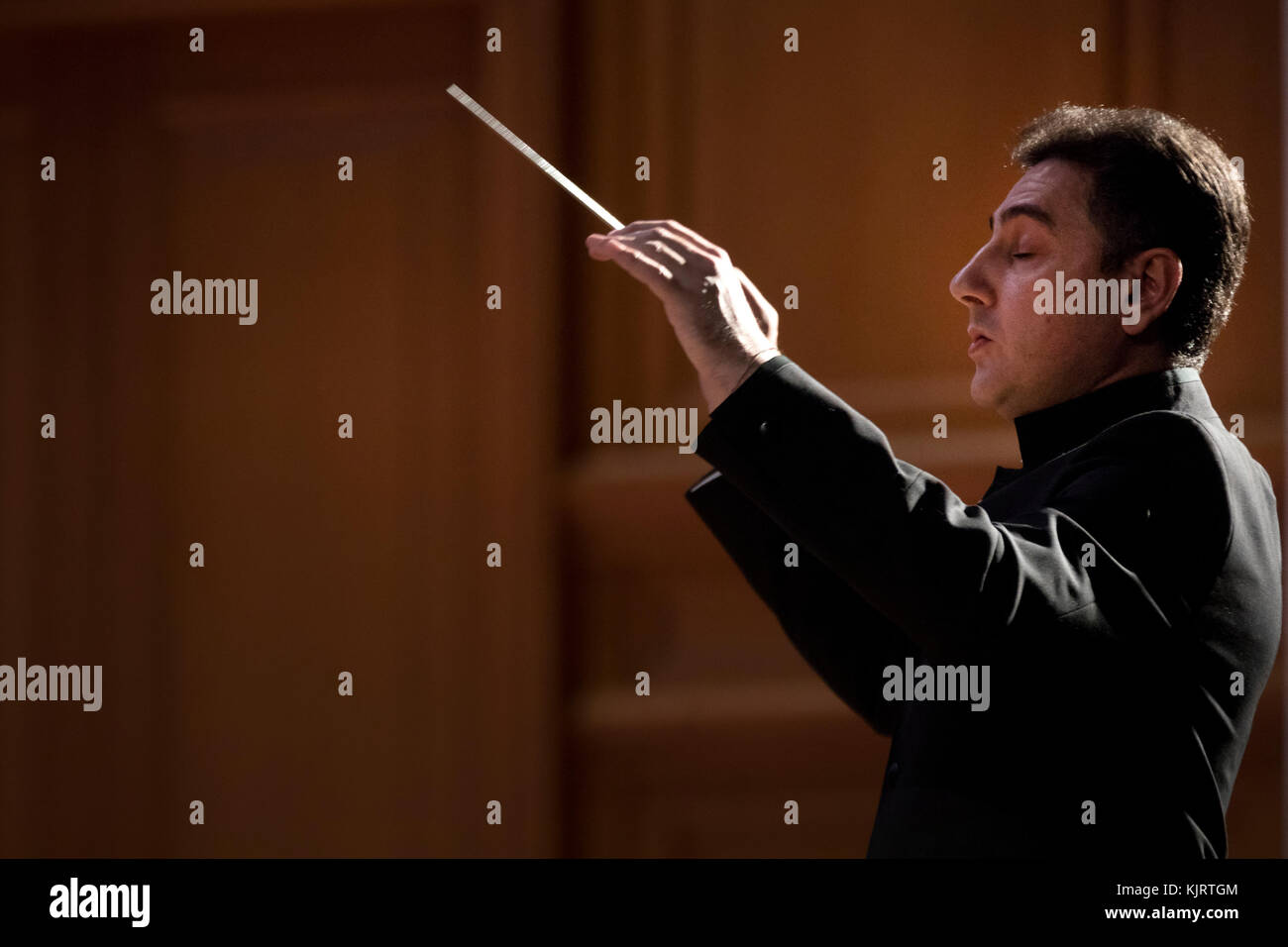 Conductor Eduard Topchyan on the stage of the Great Hall of the Conservatory in Moscow while conducting the orchestra, Russia Stock Photo