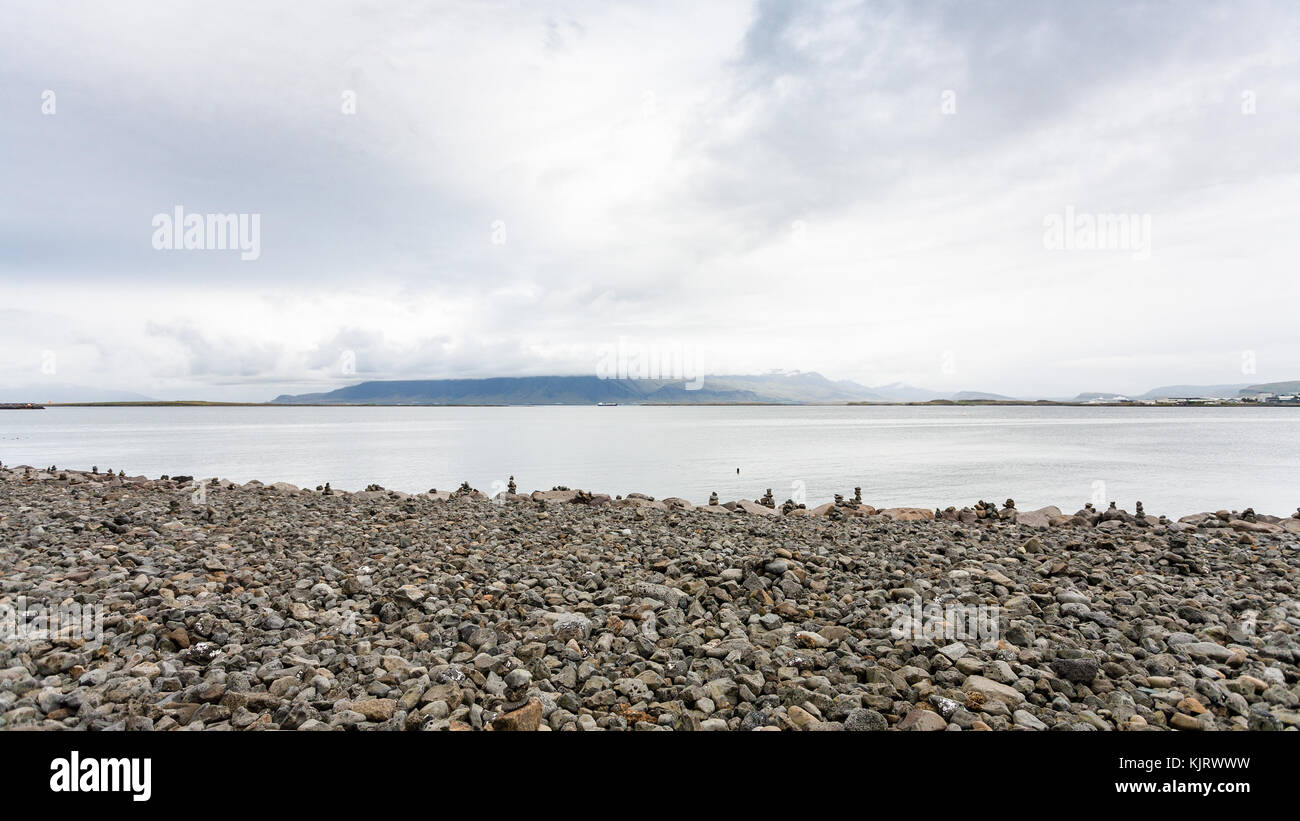 travel to Iceland cobble beach with stone pyramids at Sculpture and