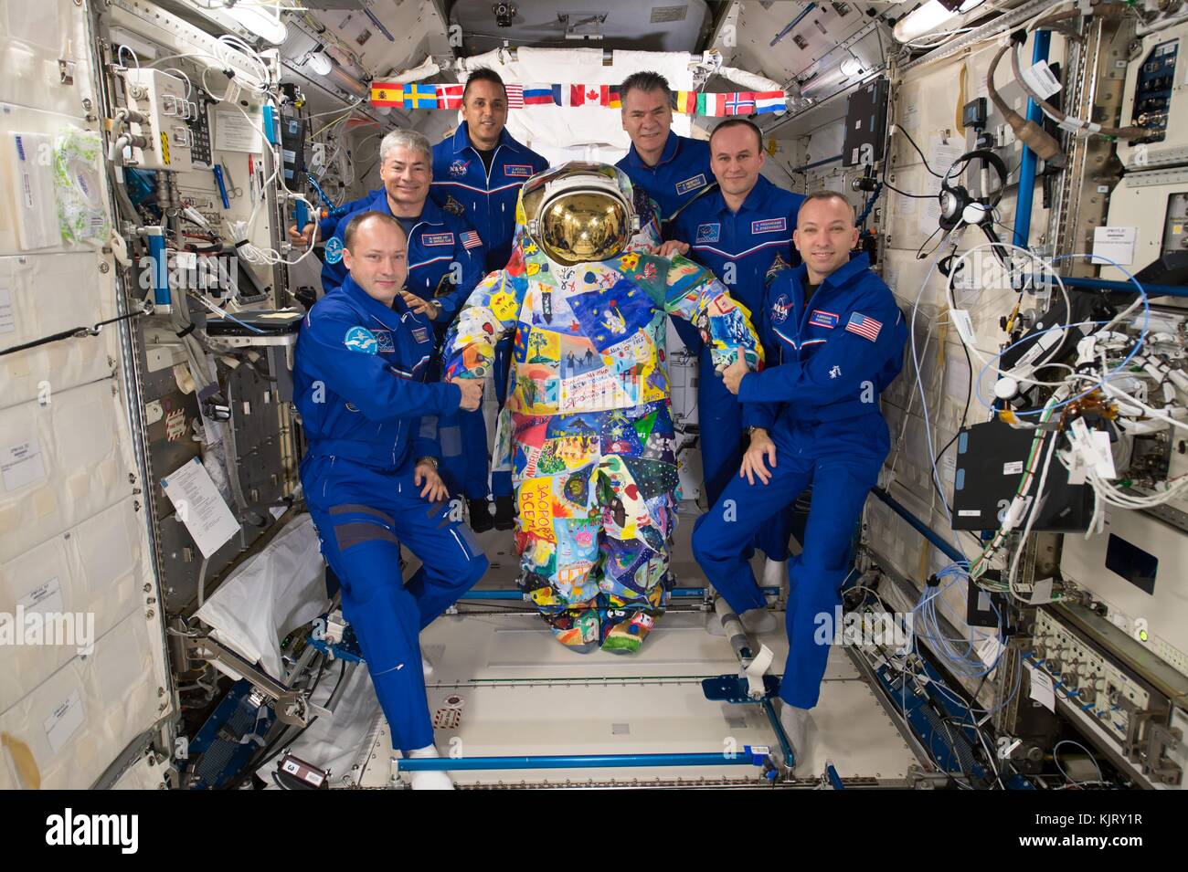 NASA Expedition 53 prime crew members (L-R) Russian cosmonaut Alexander Misurkin of Roscosmos, American astronauts Mark Vande Hei and Joe Acaba, Italian astronaut Paolo Nespoli of the European Space Agency, Russian cosmonaut Sergey Ryazanskiy of Roscosmos, and American astronaut Randy Bresnik pose with a spacesuit hand-painted by cancer patients from the M.D. Anderson Cancer Center aboard the International Space Station Japanese Kibo Laboratory module November 12, 2017 in Earth orbit.  (photo by NASA Photo via Planetpix) Stock Photo