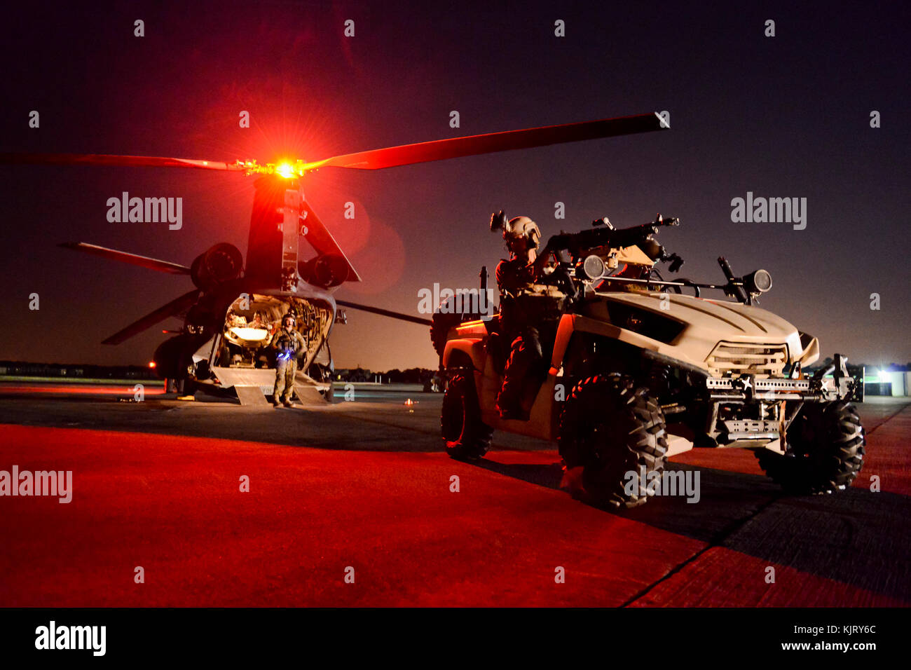 A U.S. Army special forces lightweight all-terrain vehicle is loaded on to a U.S. Army CH-47 Chinook helicopter at the McEntire Joint National Guard Base at night May 20, 2014 in Hopkins, South Carolina. (photo by Jorge Intriago via Planetpix) Stock Photo