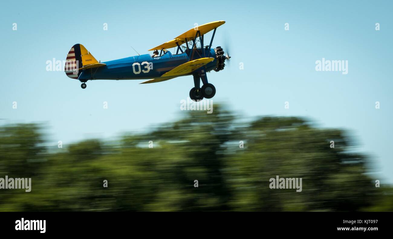 A vintage Stearman PT-17 Kaydet military trainer aircraft takes off from the runway at the Flying Circus Aerodrome during the Barnstorming Airshow July 30, 2017 in Bealeton, Virginia.  (photo by J.M. Eddins Jr. via Planetpix) Stock Photo