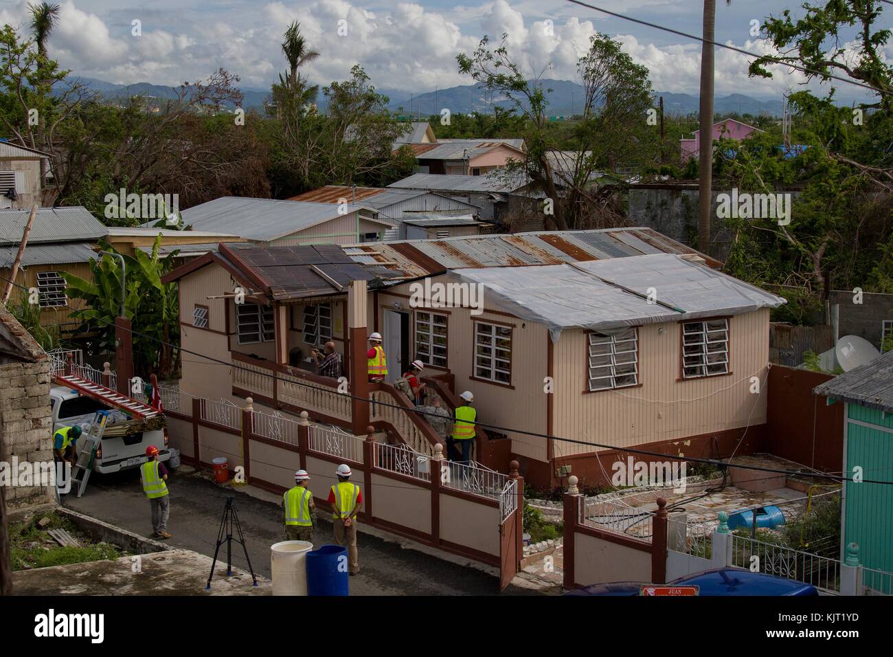 U.S. Army soldiers replaced damaged roofs with blue plastic tarps during relief efforts in the aftermath of Hurricane Maria October 28, 2017 in Ponce, Puerto Rico. (photo by Avery Cunningham via Planetpix) Stock Photo