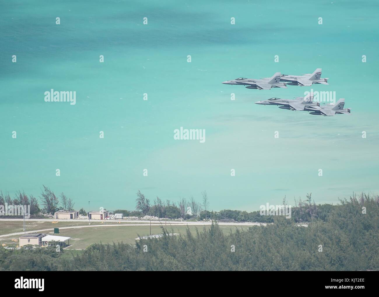 Four U.S. Marine Corps F/A-18C Hornet jet fighter aircraft fly in formation over Wake Island during a U.S. Navy Heritage event October 25, 2017 in the Pacific Ocean. (photo by Conor Minto via Planetpix) Stock Photo