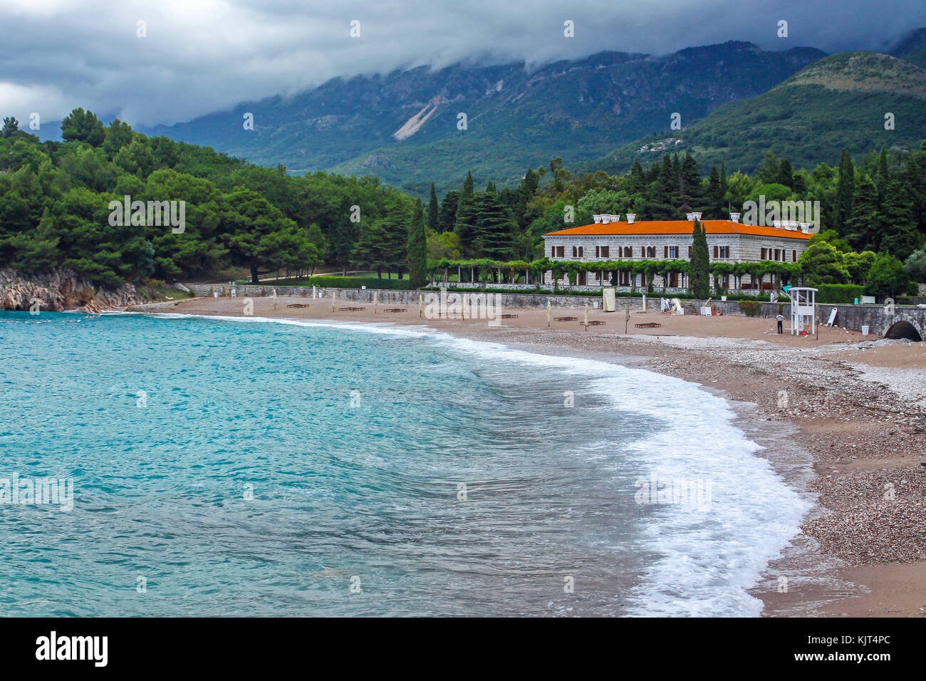 Picturesque summer view of Adriatic seacoast in Budva Riviera. Milocer beach (Milocer plaza) on the foreground. Sveti Stefan, Montenegro Stock Photo