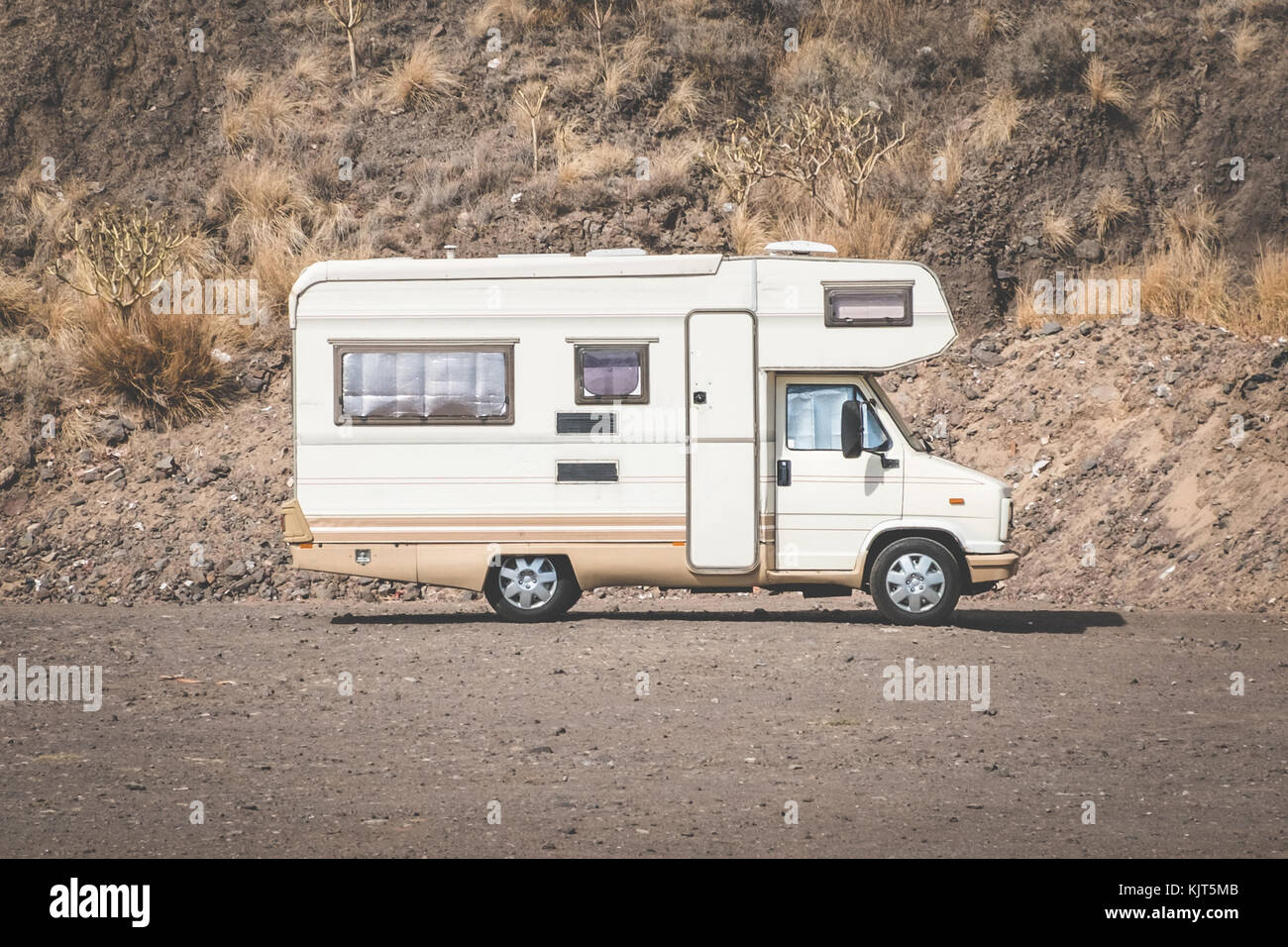 vintage camping bus, rv camper in desert landscape, Stock Photo