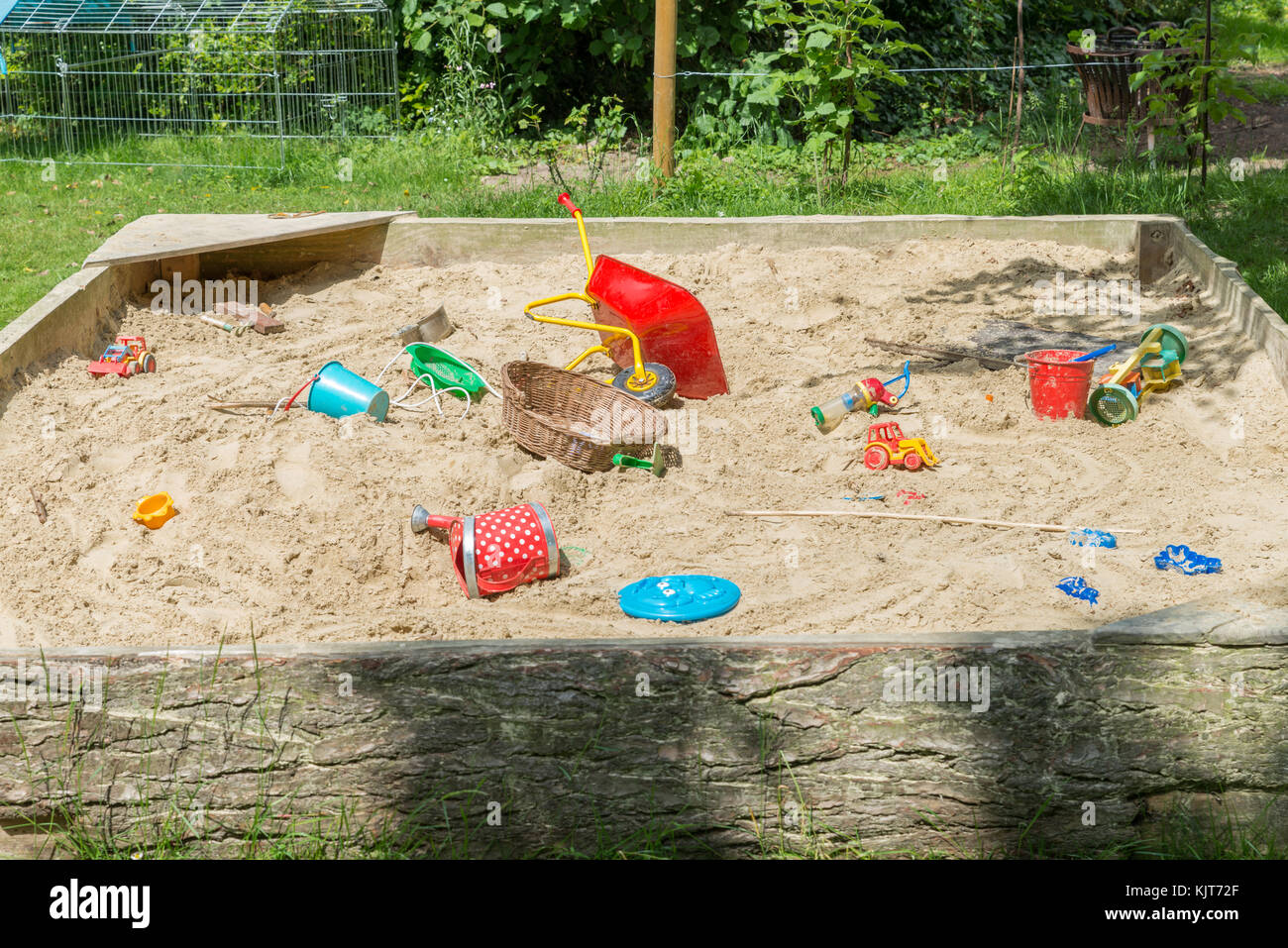 Big sandbox with many toys in a garden Stock Photo