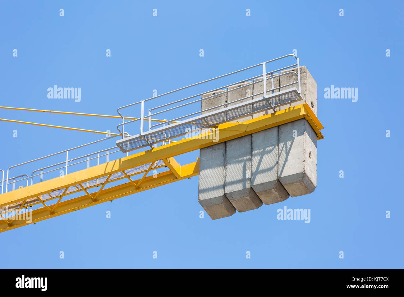 Concrete massive counterweight of a crane on blue clear sky Stock Photo