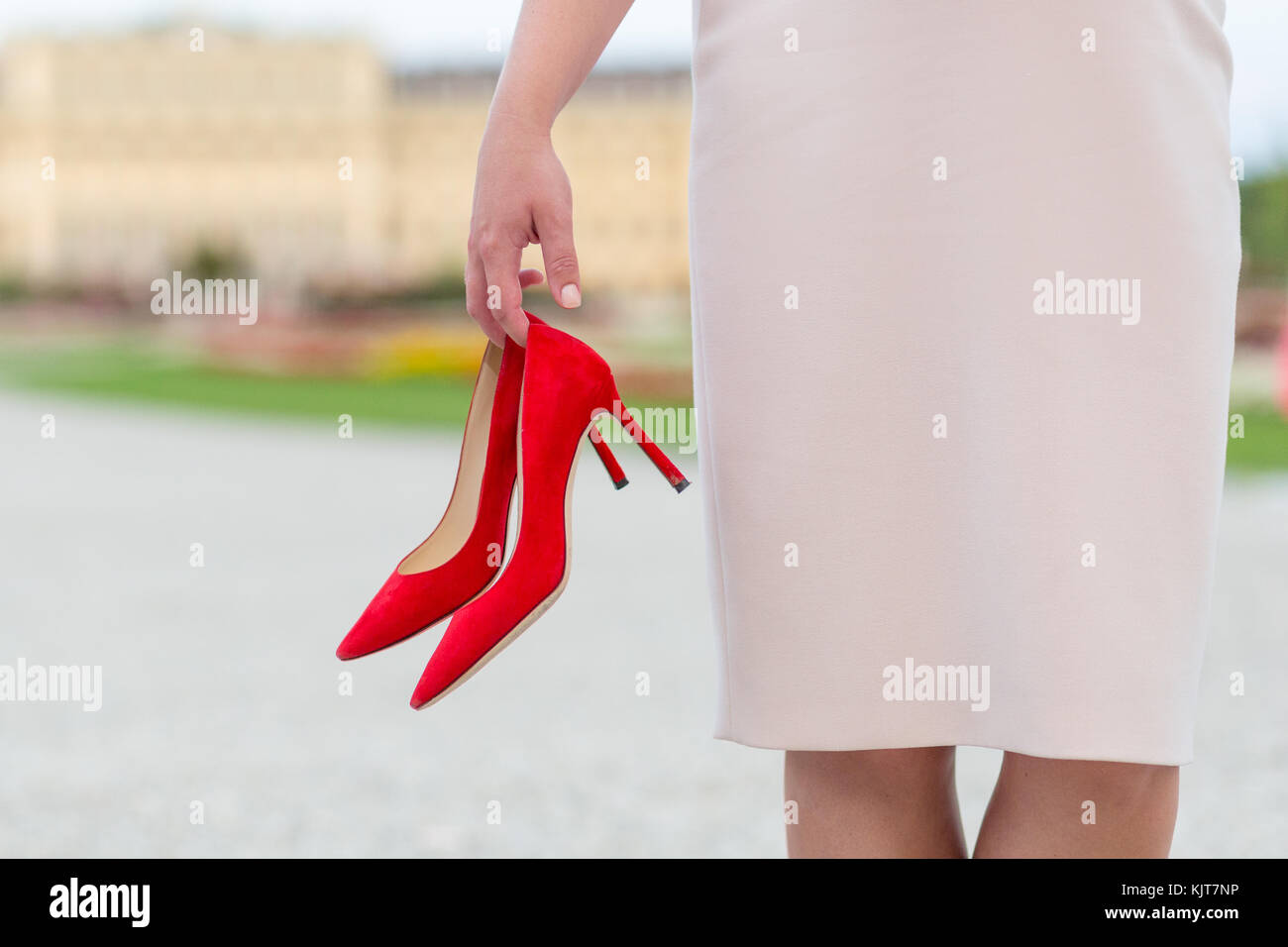 An elegant woman holding luxury red high heel shoes in her hand Stock ...