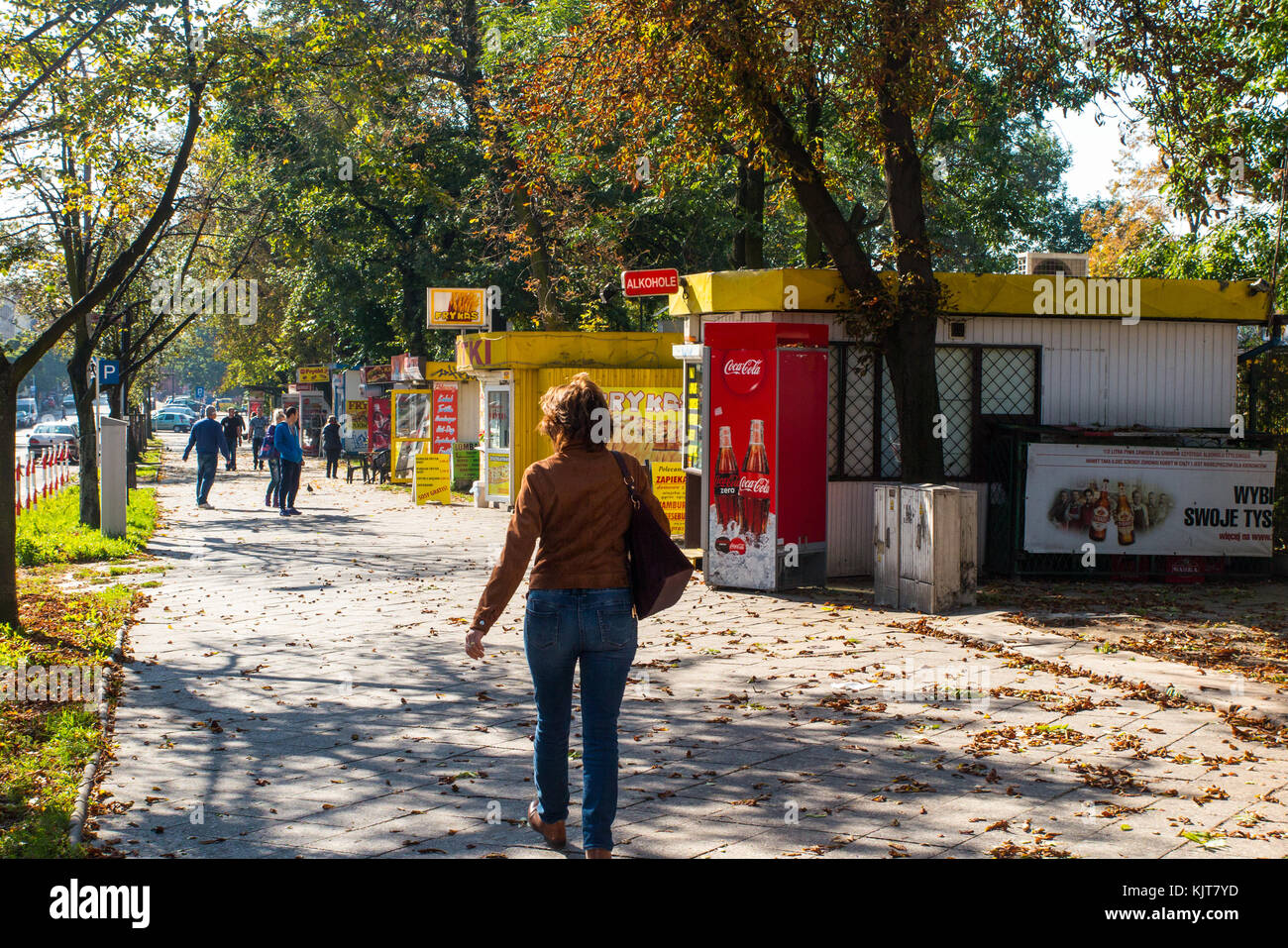 People walking along a street past small food and drink stalls / outlets in the Polish city of Czestochowa Poland  during Autumn time Stock Photo