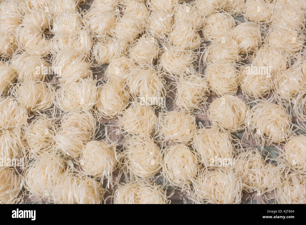 Fresh made rice noodles to dry in the sun in Vietnam Stock Photo