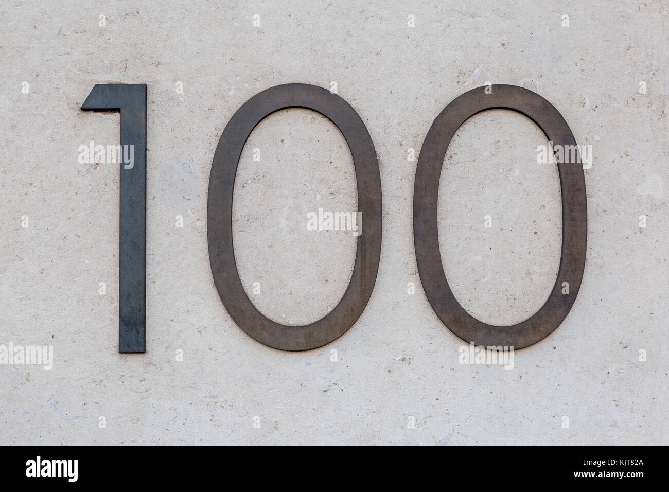 A metal sign for 100 / hundred on a wall in London, UK Stock Photo