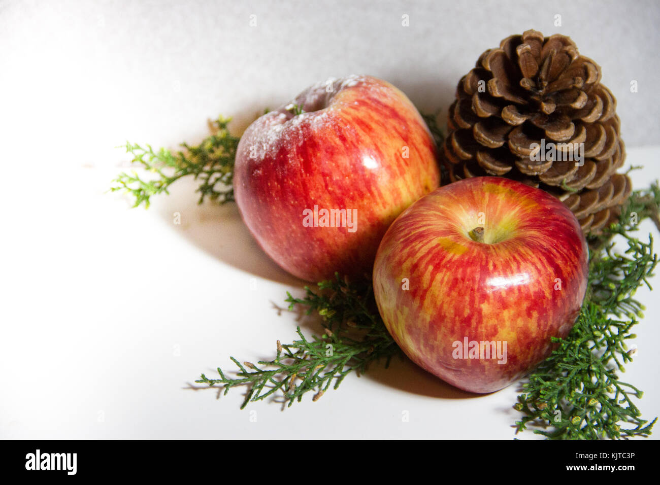 Christmas decoration with red apples, pines and pineapples Stock Photo