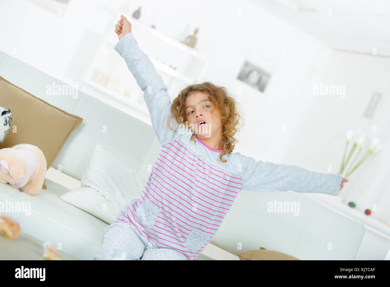 Little girl yawning Stock Photo - Alamy