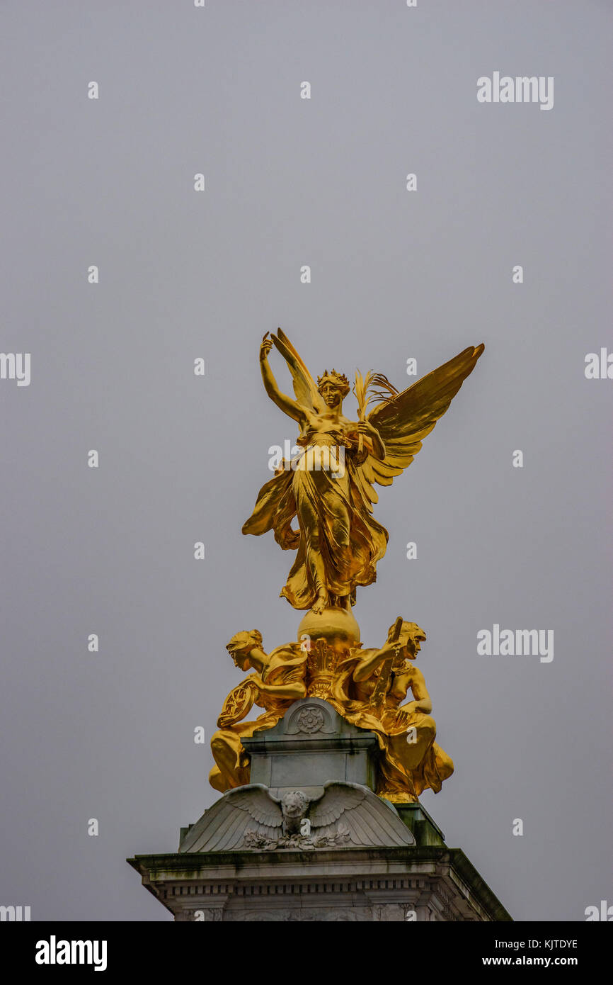 Golden statue of wisdom in front of Buckingham palace on the (Queen