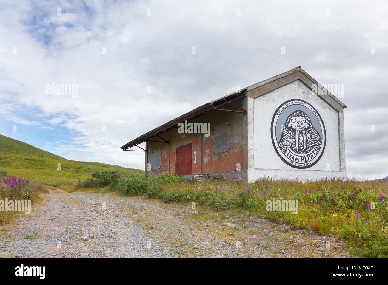 Dutch Harbor, Unalaska, Alaska, USA - August 14th, 2017: Old house with a graffiti of the Team Alpat located at Tundra Dr, near the Unalaska Airport. Stock Photo