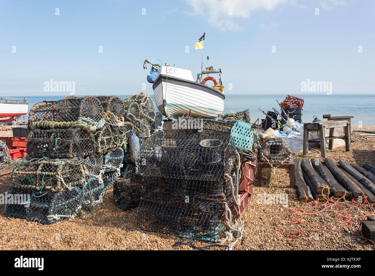 Lobster pots and fishing boat on beach, Deal, Kent, England, United Kingdom Stock Photo