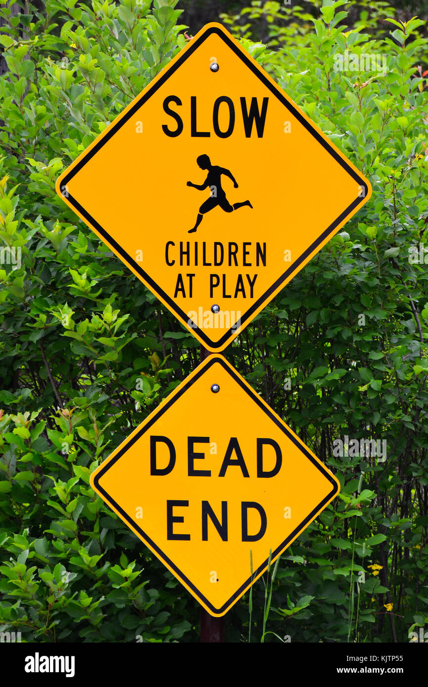 Residential area traffic warning signs indicating both children at play and a dead end street. Stock Photo