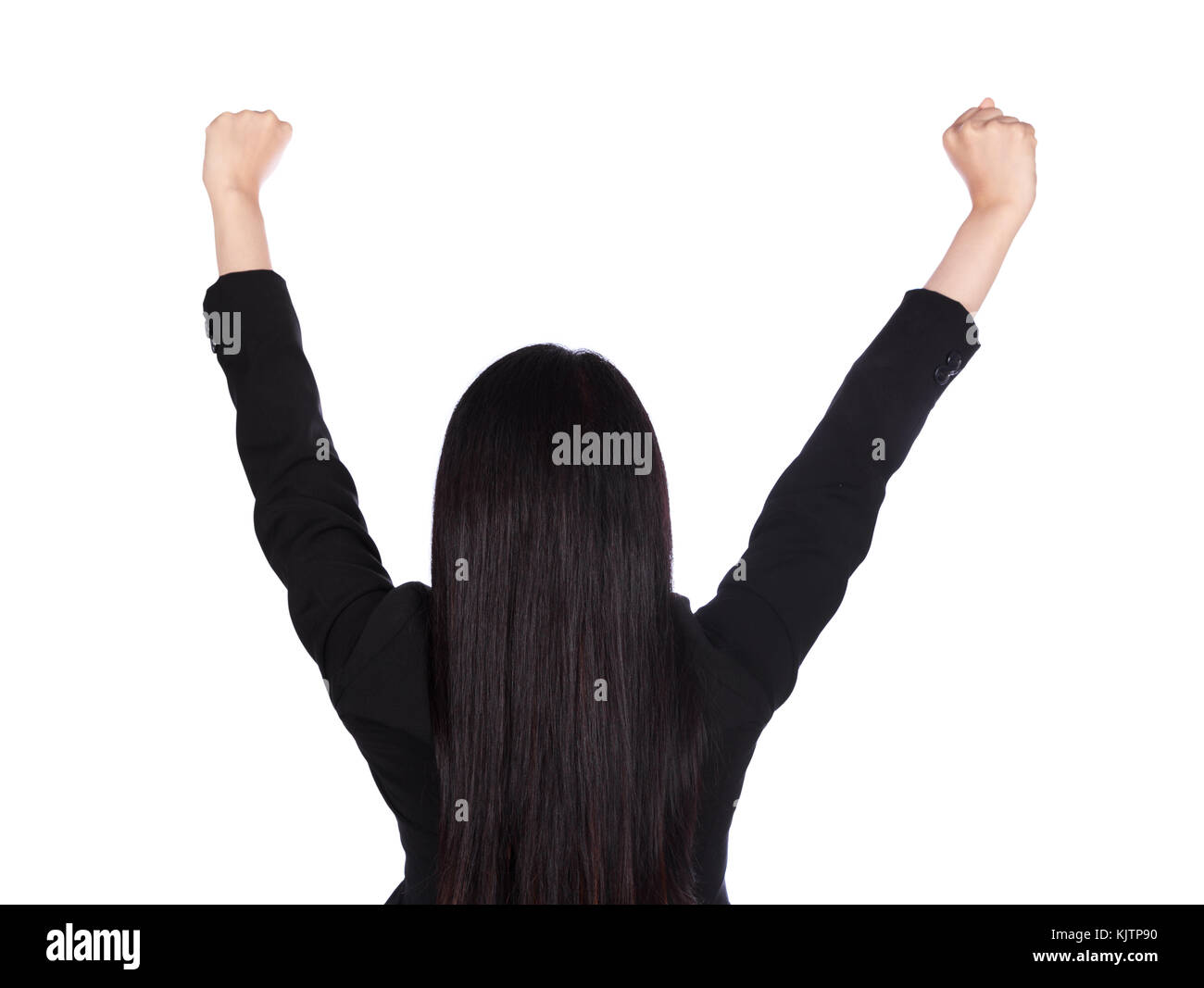 rear view of young business woman cheering with her arms raised ...