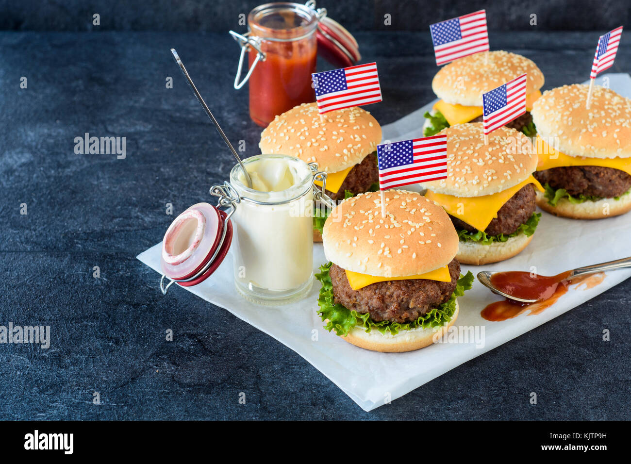 Mini beef cheeseburgers with American flags on top,selective focus Stock Photo