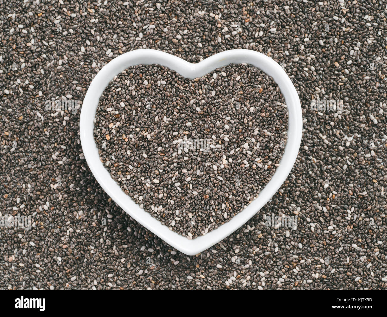 Heart-shaped bowl of chia seeds Stock Photo