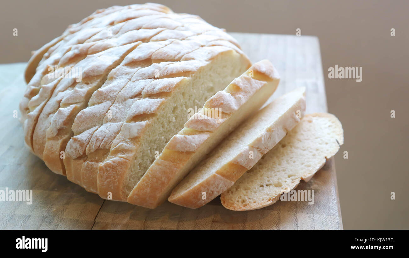 sliced baguette or sliced bread on the block Stock Photo - Alamy